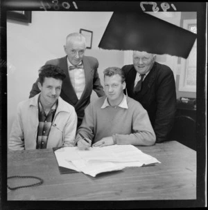 Boxers Barry Brown and Charlie Beaton sign up for match while two unidentified men look on