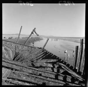 Part of the ship wreck Hydrabad at Waitarere Beach, Levin. Toheroa hunters in the background.