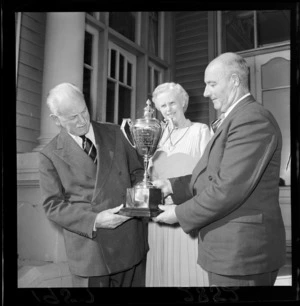The Governor-General of New Zealand Sir Charles Willougby Moke Norrie, left, and Lady Patricia Norrie, presenting the Norrie Trophy to Mr HD Gillies, president of the New Zealand Surf Life-Saving Association