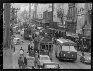Traffic in Willis Street during a Friday peak hour, Wellington, including tram, buses, cars, building of Wardells Supermarket and Lowes Book Shop
