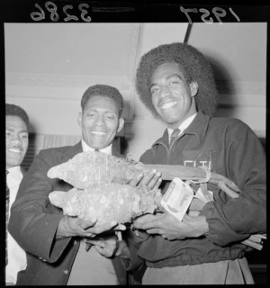 Fijian rugby players with taro sent from home