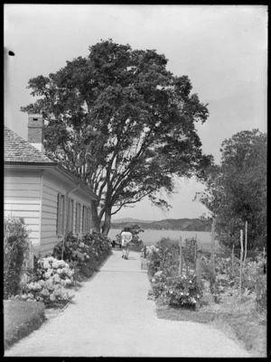 Women walking down a path beside the Treaty House, Waitangi
