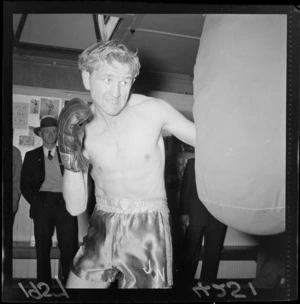Boxer Jimmy Newman punching a training bag