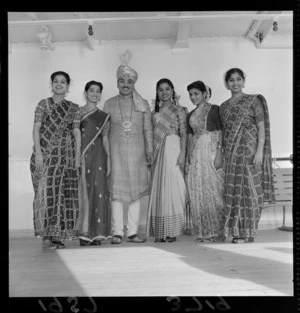 Indian magician in costume with assistants