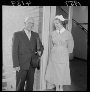 Arnold Henry Nordmeyer with an unidentified nurse, leaving the hospital
