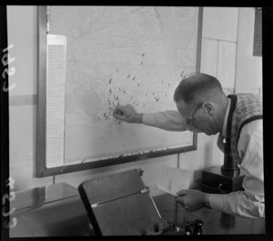 Putting pins on to world atlas at Tinakori Radio Station, Wellington