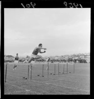 Mr J H Joyce competing in the hurdles for Australian Universities at Athletic Park, Wellington