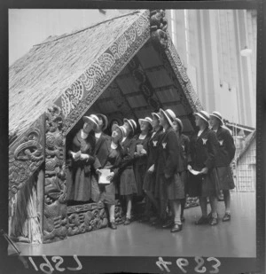 Girls from Woodford House School, at the Dominion Museum, with the exhibited carved house