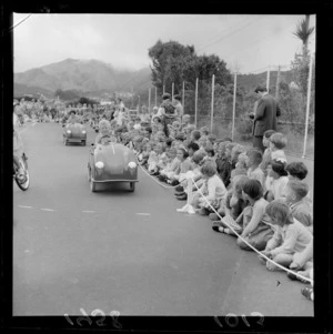 Traffic training, Karori School, Wellington, children riding pedal cars around the school yard