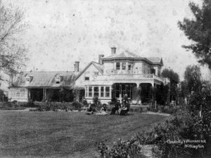 Group (probably members of the Pharazyn family) in the garden, outside the farmhouse at Longwood Station, Wairarapa