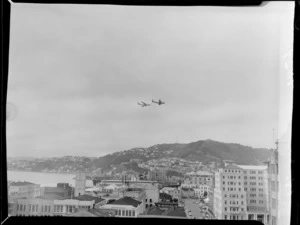 An American Stratojet Bomber aircraft flying alongside another aircraft over Wellington