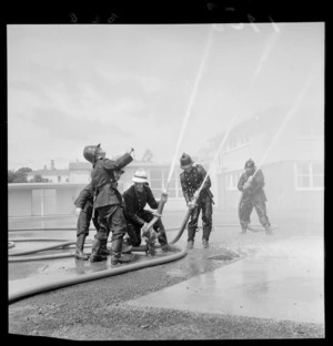 Volunteer fireman, practicing with hoses, Island Bay Training School, Wellington