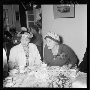 Lady Dorothy Macmillan, wife of the British Prime Minister, Sir (Maurice) Harold Macmillan, with an unidentified woman, at luncheon, Wellington