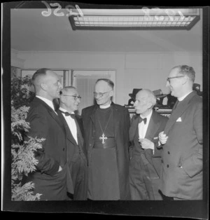 Five unidentified men, two in clerical clothing, at a Jewish dinner