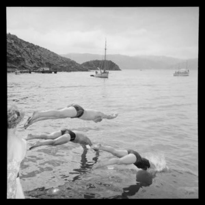 Swimmers diving into the water during a swimming race between Somes/Matiu Island in Wellington Harbour and Petone, Lower Hutt