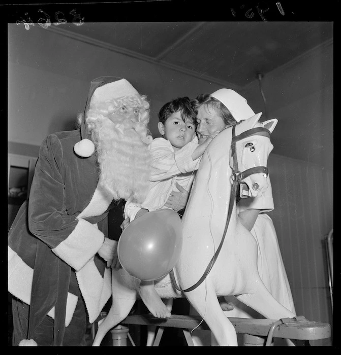 Children in hospital being visited by Santa Claus