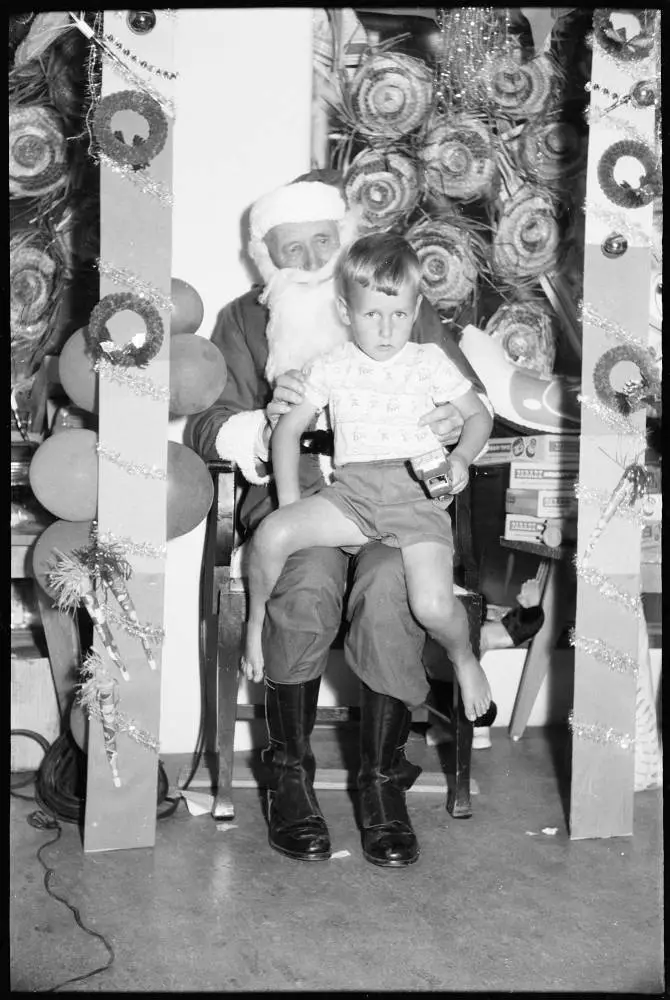 Children sitting on Santa's knee, 1959