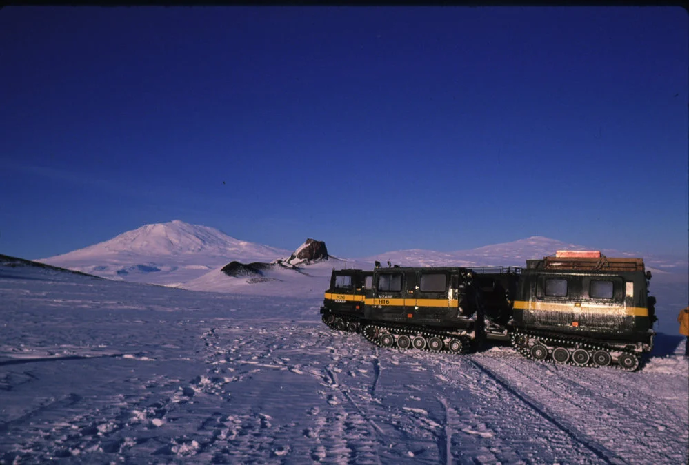 2 Hägglunds with Castle Rock and Mt Erebus in the background