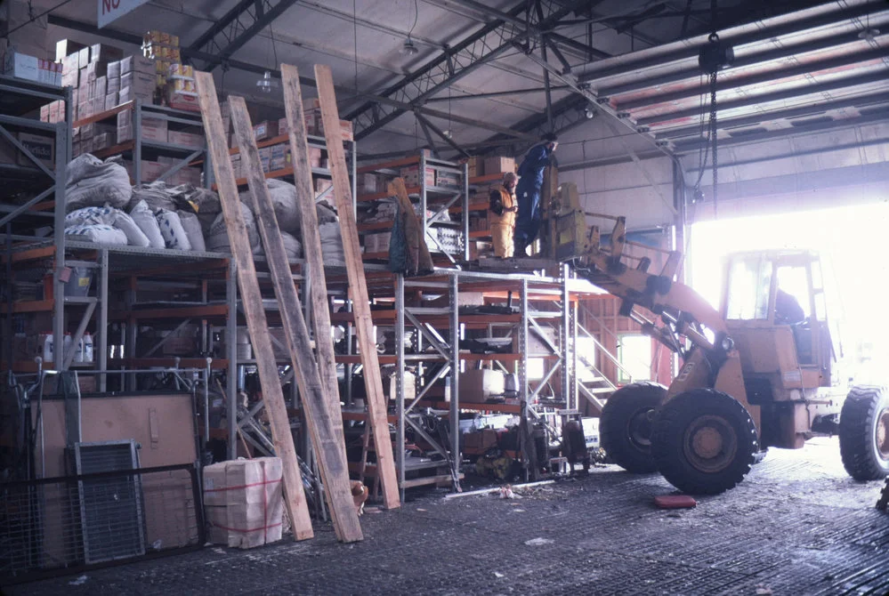 East wall hangar- stocking new shelving on mezzanine floor