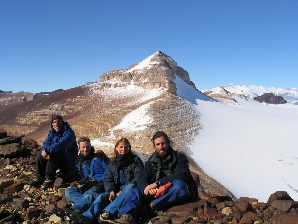 K047 members (L to R) Warren Dickinson, Andrew Mackintosh, Leigh Hyland, and Dan Zwartz, sitting on Brawhm Pass with Altar Mt in background