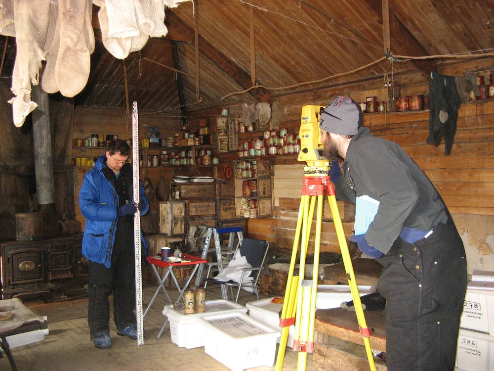 Nic Donnelly Aaron Jordan surveying in Shackleton's Hut at Cape Royds