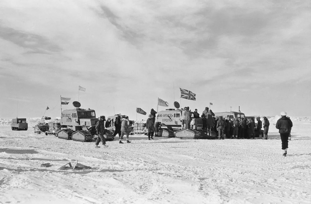 The crossing party is welcomed at Scott Base on 2 March 1958 after completing the first overland crossing of Antarctica, a journey that took 99 days