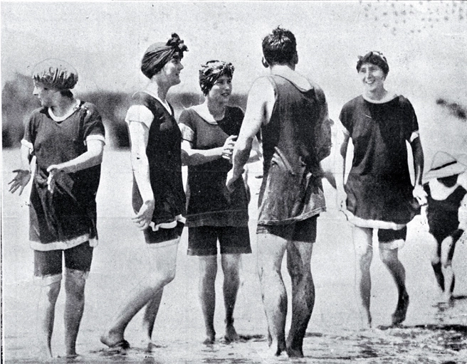 A group of young bathers in bathing costumes in the surf at Sumner beach on the Anniversary Day of Christchurch