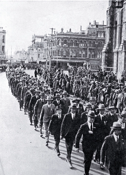 Returned soldiers in mufti and wearing medals marching past the Cathedral, Christchurch