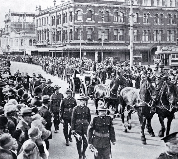 The gun carriage and firing party follow the wreath bearers, Christchurch