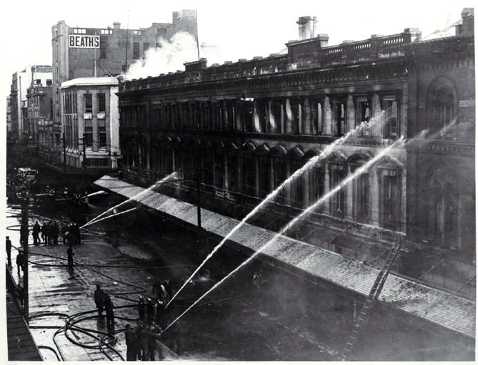 Firemen dampening down Ballantyne's building, Christchurch