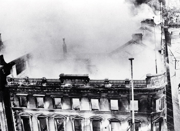 View of still smoking Ballantyne's building from the corner of Cashel and Colombo Streets, Christchurch