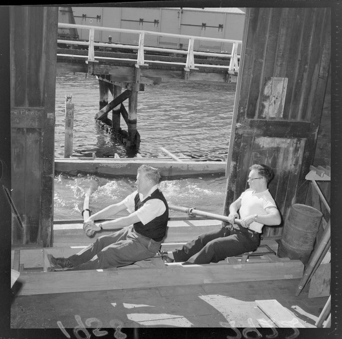 Two unidentified men demonstrating a rowing practice device at the Star Boating Club, Wellington