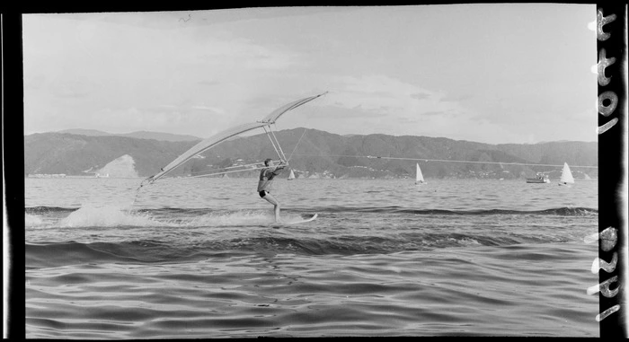 Waterskiing demonstration off Petone Beach, Wellington Region, including man being towed while holding kite and attempting to fly