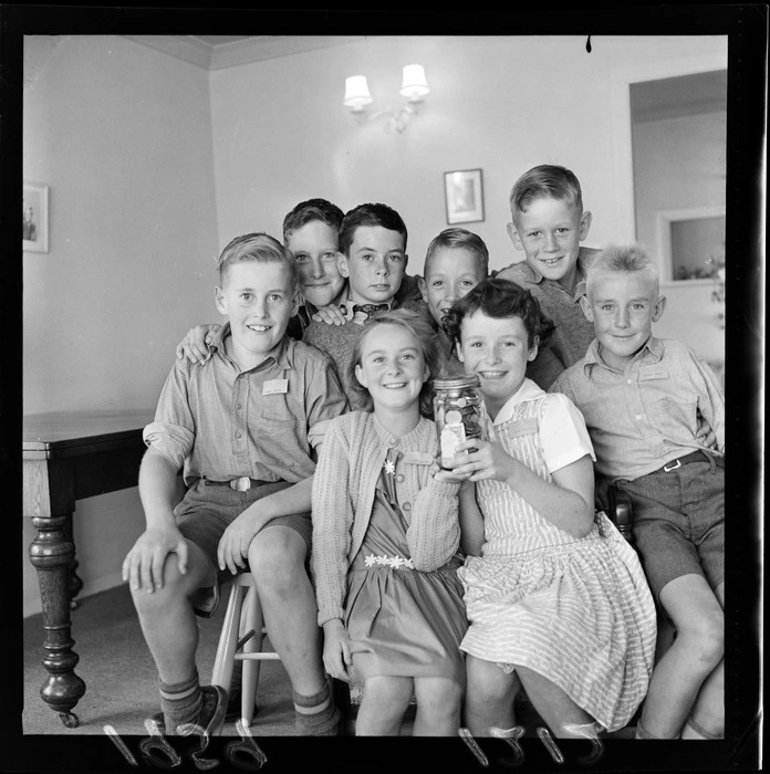 Children from the Taita 'Save A Leper Club' with a jar of money, Lower Hutt, Wellington Region