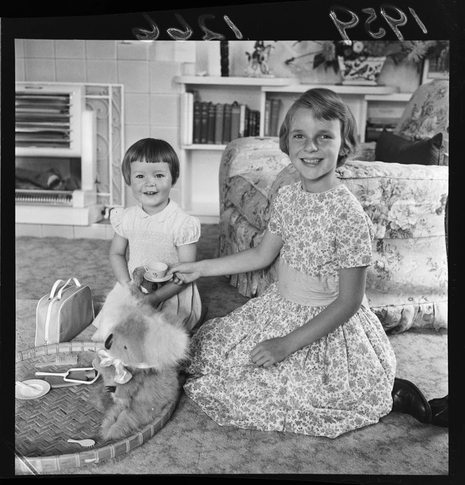 Princess Melissa, daughter of the Prince of Thailand, playing with Virginia Butler, including tea set, soft toy koala bear, and brush and mirror set