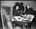 Portrait of  Rex Nan Kivell (left) handing over his collection of early Australian items to Senator the Hon. Sir Alistair [i.e. Alister] McMullin, President of the Senate, at a ceremony at Australia House, 16 January 1959 [picture] /