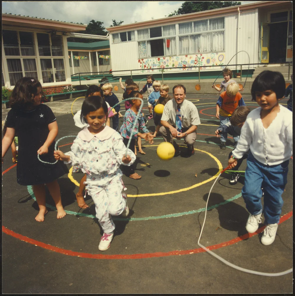 Children in playground with principal. Skipping and balls