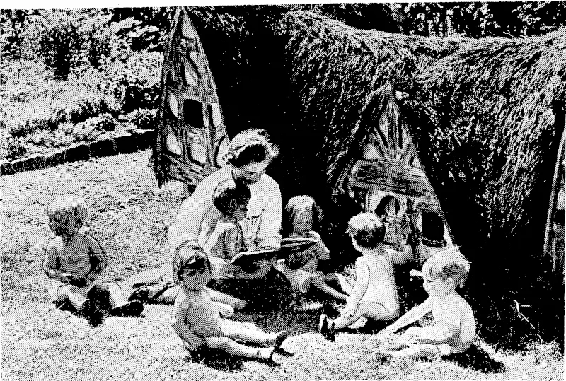 Llllle sunbathers outside a model house at the Duchess of York's Hospital for Babies at Burnage, Manchester. The nurse is jeading a fairy tale to her charges. (Evening Post, 13 January 1940)