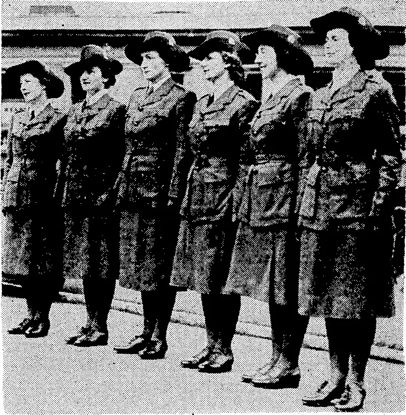 Evening I Post" Photo.. Tlie uniform which is being worn by the Women's War Auxiliary. Coat and skirt are greenish khaki in colour, and tlieir felt hats are turned up at the side and pinned with a Neiv Zealand badge. (Evening Post, 02 September 1941)