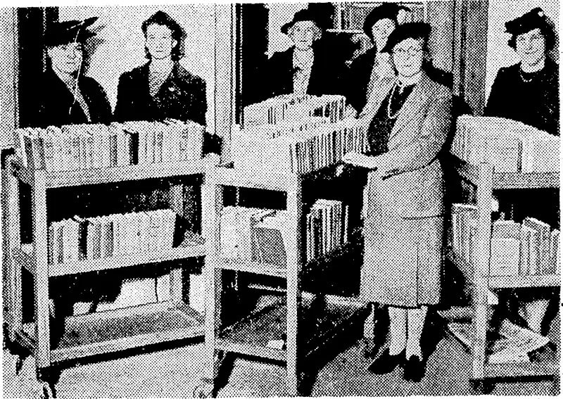 Members of the library section of the Wellington Hospital Women's Auxiliary with some of the ivagons used to take books to patients. Mrs. O'Leary, who has been honorary librarian fouls years, is in the foreground, the other ladies being some of Jier assistants. (Evening Post, 23 October 1943)