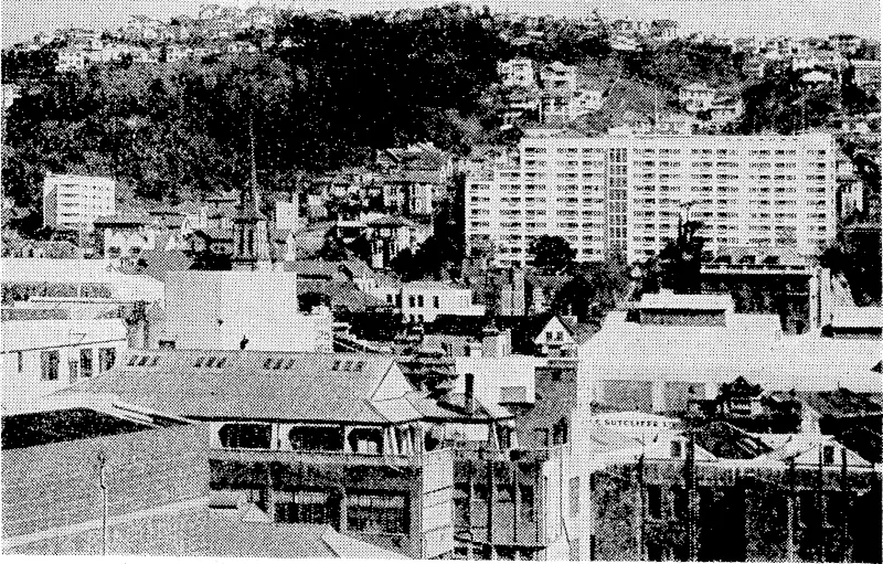 Wellington's changing skyline, looking towards the heights of Kelburn, with the Dixon Street Flats towering up on the right and the newer Terrace Flats on the left. The steeple in the left foreground is that of St. John's Presbyterian Church. (Evening Post, 28 September 1944)