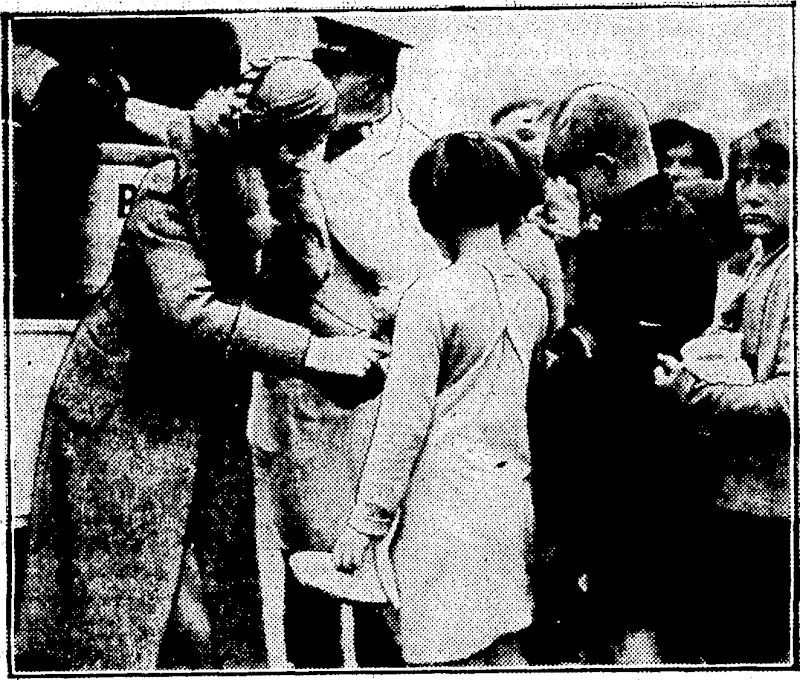 Evening Post" Photo. HER EXCELLENCY DISPENSES HOSPITALITY.—Lady Bledisloe assisting with the distribution of soup and bread yesterday when their Excellencies visited the Salvation Army's travelling soup kitchen at Auckland. (Evening Post, 23 June 1933)