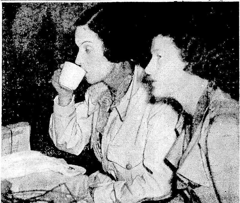 TEA AFTER LONG FLIGHT.—Mm Jean Batten taking a cup of tea with another airwoman, Miss Nancy Bird, at.Sydney on Tuesday after the New Zealandcr's arrival from London on her recordbreaking flight. . (Evening Post, 17 October 1936)