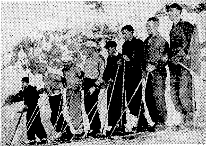 Evening Post" Photo. Competitors .who 'took:part,in the open langlauf, a cross-country ski race of three miles auhe Ruapehw. Ski Club's snoio sports-at Tongariro< National Park\ last week. The winner was J. Loveridge^-whp is fourth from the left. ■ ■■'■■■■■'.■■".■' (Evening Post, 08 September 1937)