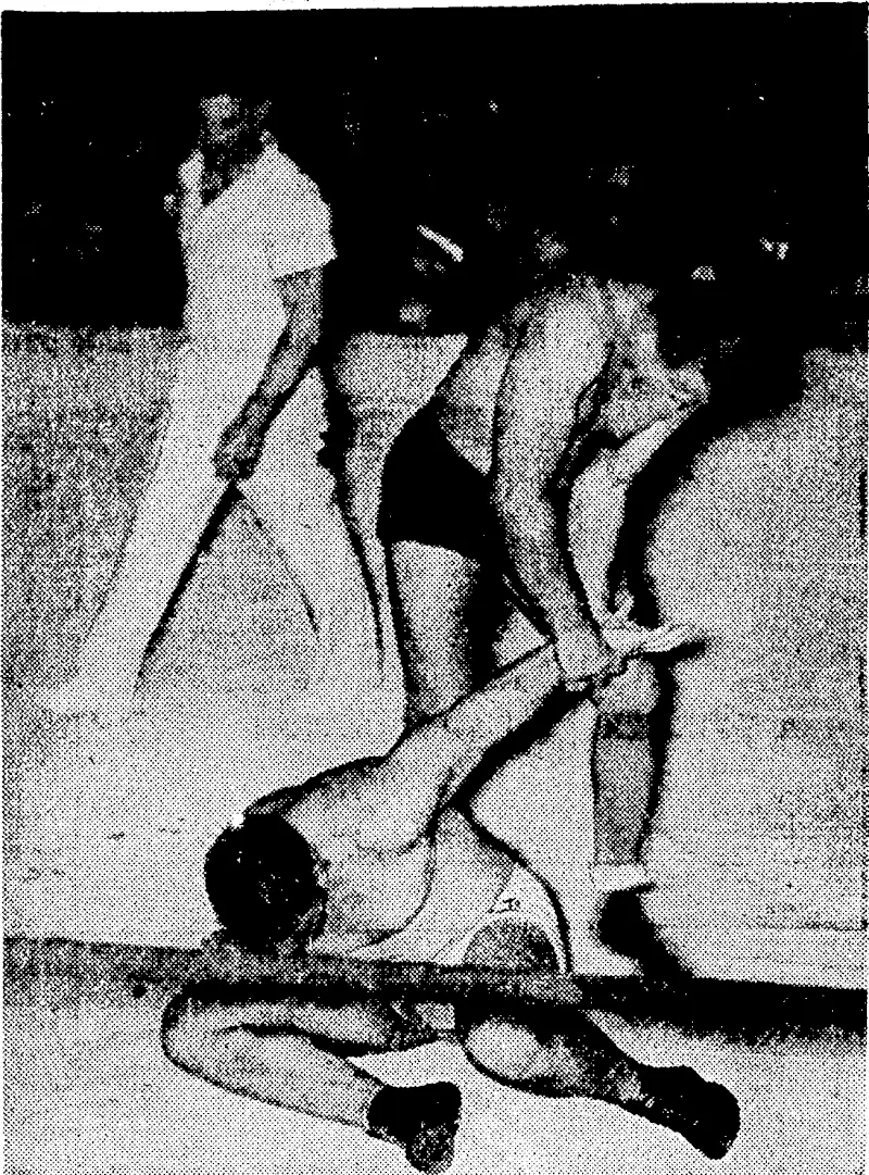 Frank Judson endeavours to twist "Lofty" Blomfield's arm out <>I its socket during their match at the Town Hall. ".i...". : ■ ' – ■ (Evening Post, 11 September 1937)
