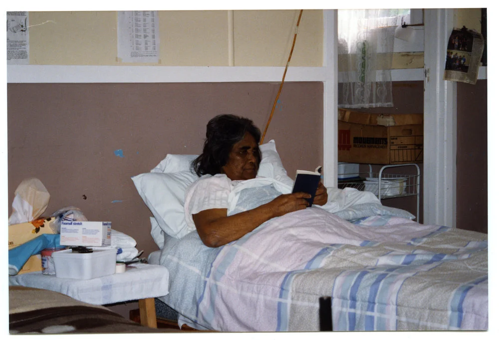 A patient reading in bed at the Maori Health Clinic
