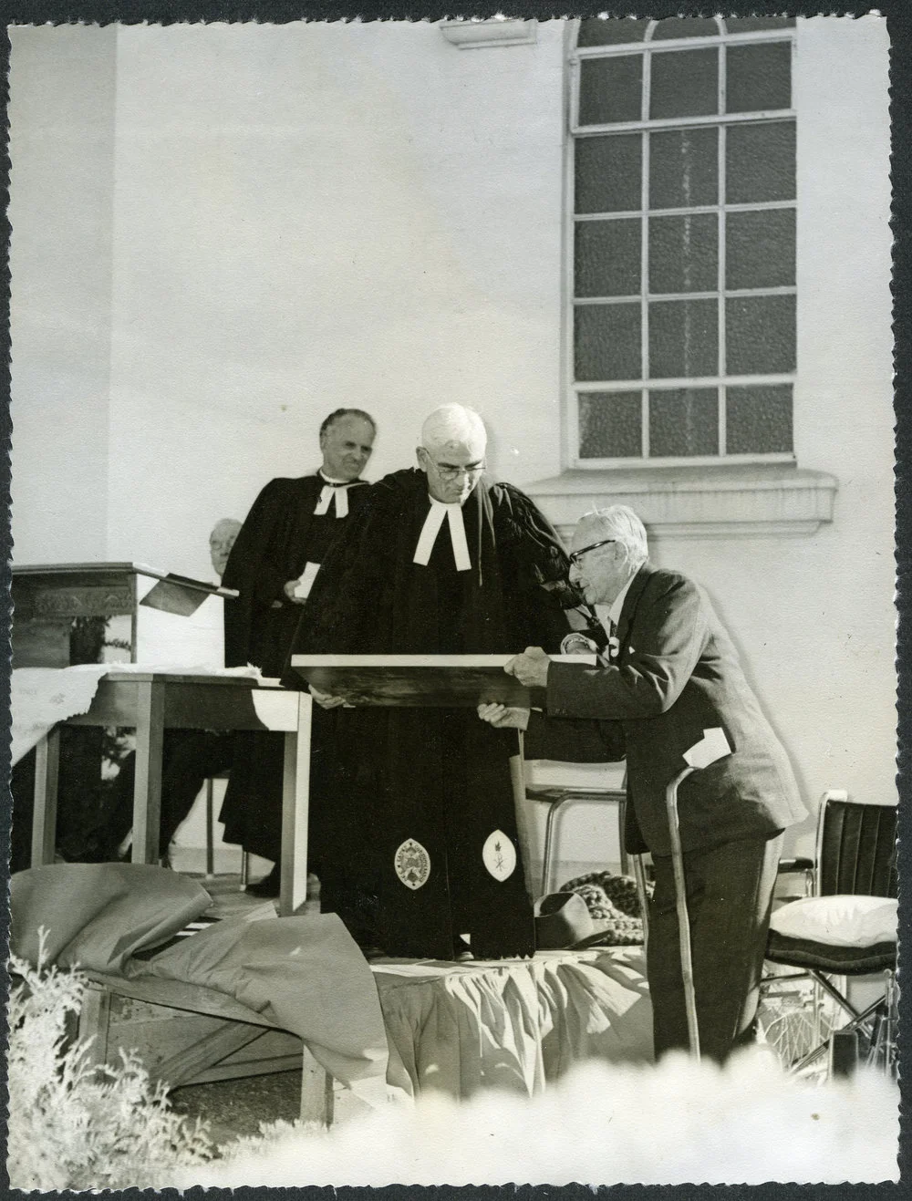 Right Reverend Luke Jenkins presents the Minister of John Knox a plaque to commemorate the centenary of the church, 1972