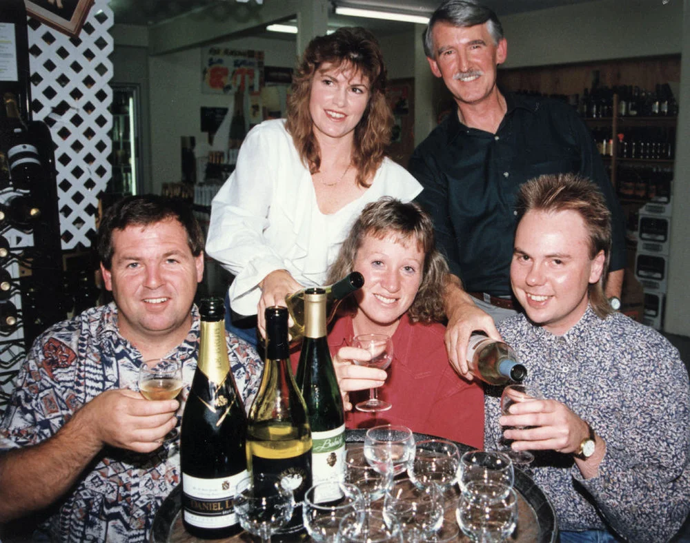Smugglers, corner of King Street & Fergusson Drive; owner Brian Carey and Andrea Quinn with wine club members.