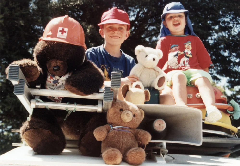 Teddy bears' picnic, 1999; Mitchell Tyler and Fraser Hoyland on the Red Cross Landrover, Harcourt Park.