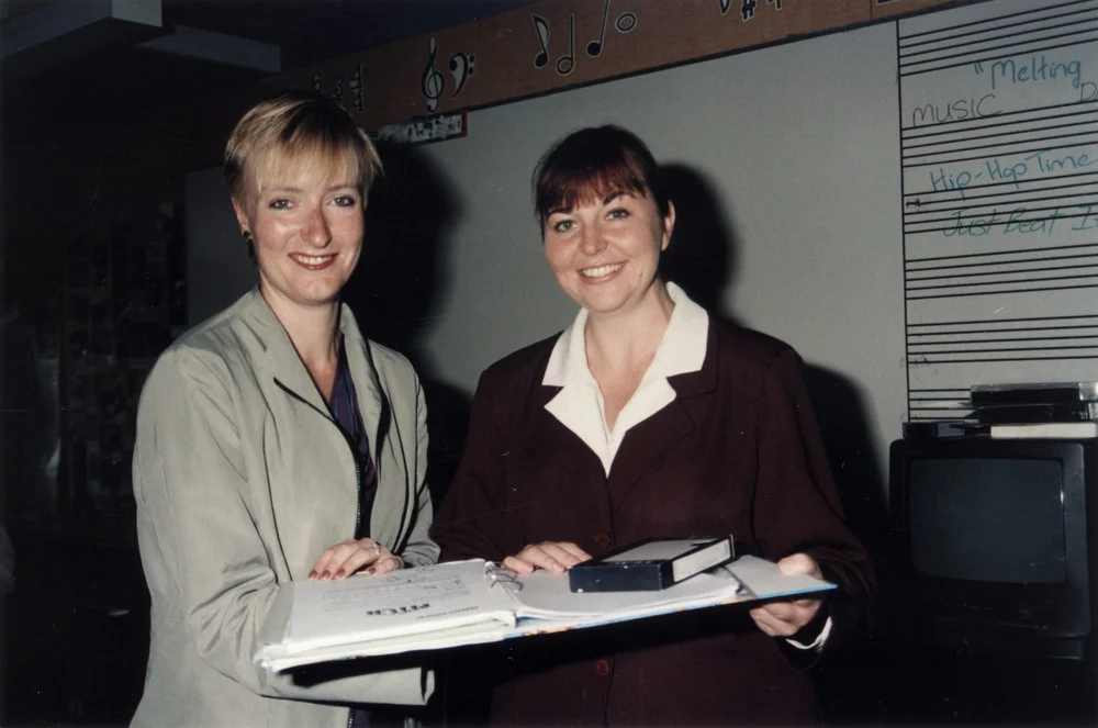 Teachers Tracey McLennan and Ellie Watts with video and proof of their book 'The Melting Pot'.